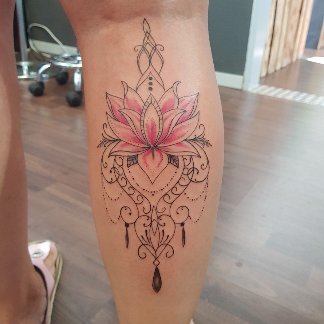 Illustrative style lotus flower tattoo on the left