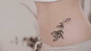 Pelvis tattoo on each sides - scars covering - symmetrical - plants - botanical