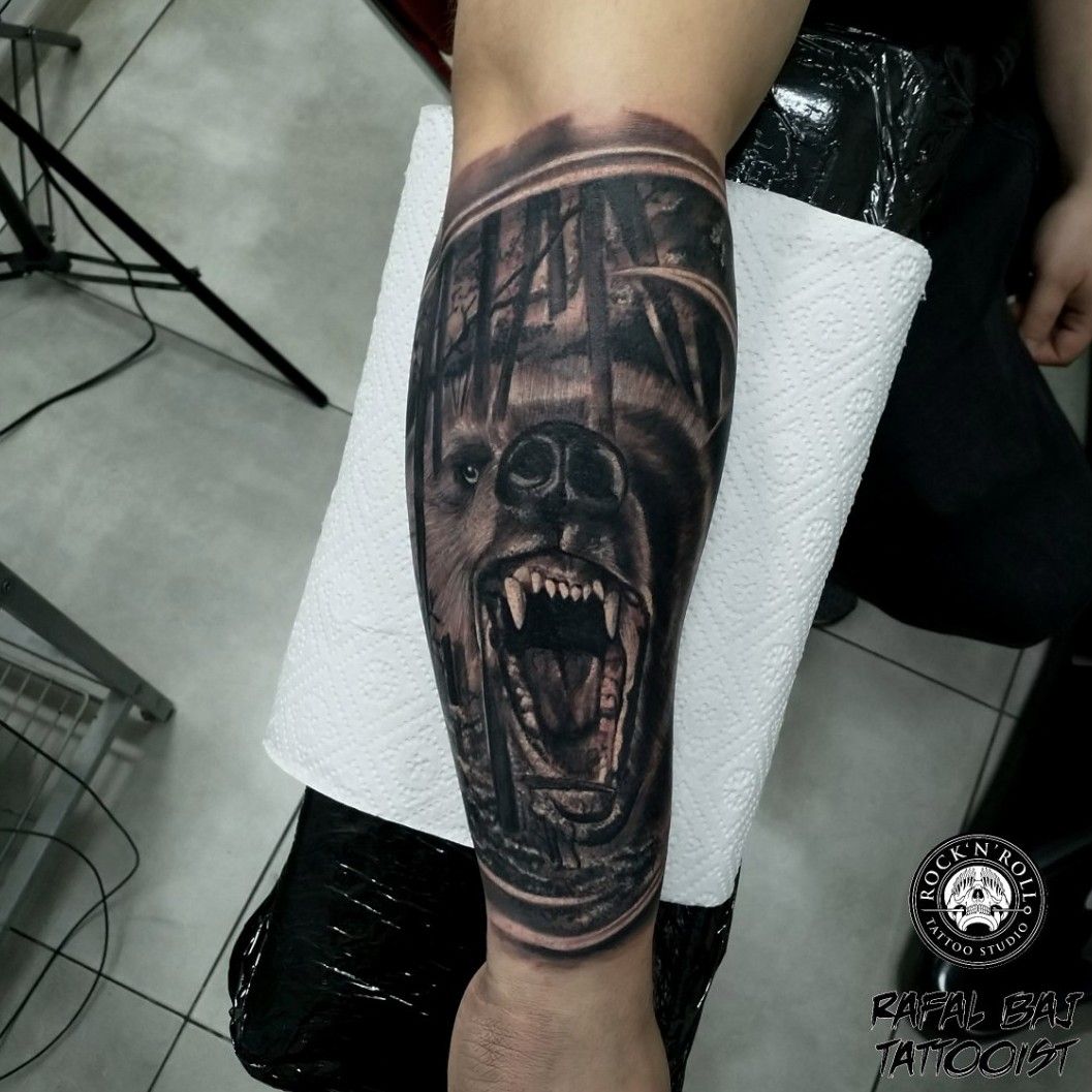 Black and grey bear tattoo on the right inner forearm