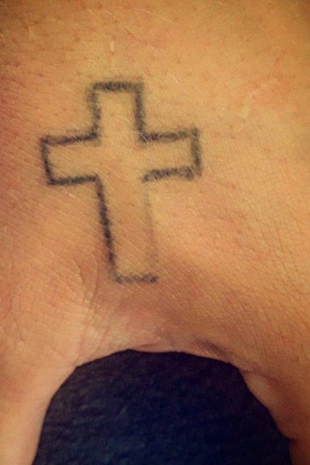 What does an upside down cross tattoo on the face mean  Quora