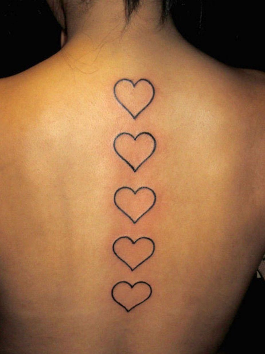Upper back tattoo of a heart including an A