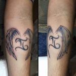 Gemini sign tattoo with one angel wing and one demon wing