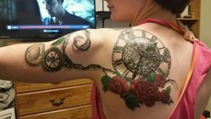This was my very first tattoo, god that seems like forever ago. Anyways its a steampunk clock with roses and rose vines to hook the compass