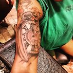 Pers clock uper arm tattoo