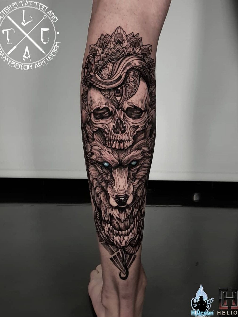 Black and grey skull tattoo on the right calf