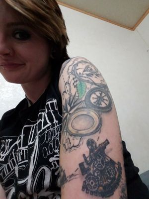 Here's my upper arm, here I have a sextant, a compass and a compass rose. More map design and both the compass and vine are from my very first tattoo (another peice I posted on here) 