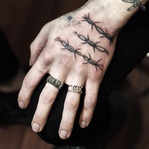 Tattoo by Kane Trubenbacher #KaneTrubenbacher #barbedwire #blackandgrey #linework #metal #wire #handtattoo #oldschool #illustrative