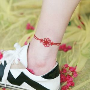 A red knotted anklet around the ankleby SION (@tattooistsion) #flowertattoo #floraltattoo #Korea #KoreanArtist #tattooistsion #colortattoo #flower #flowers #oriental #ankletattoo 
