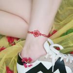 A red knotted anklet around the ankleby SION (@tattooistsion) #flowertattoo #floraltattoo #Korea #KoreanArtist #tattooistsion #colortattoo #flower #flowers #oriental #ankletattoo 