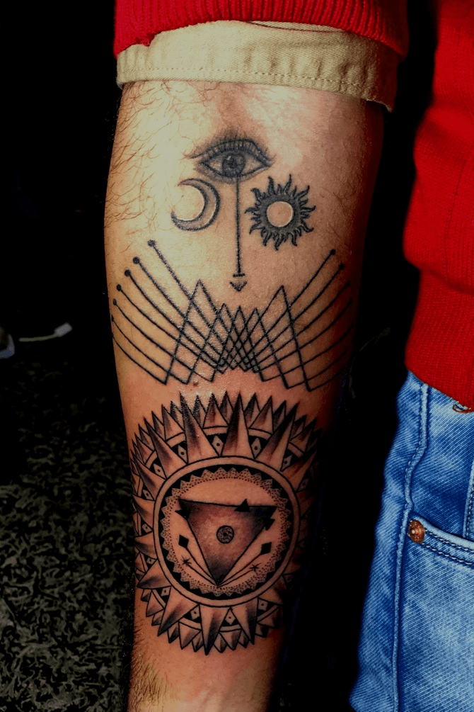 Henna inspired sun and moon tattoo on the left arm