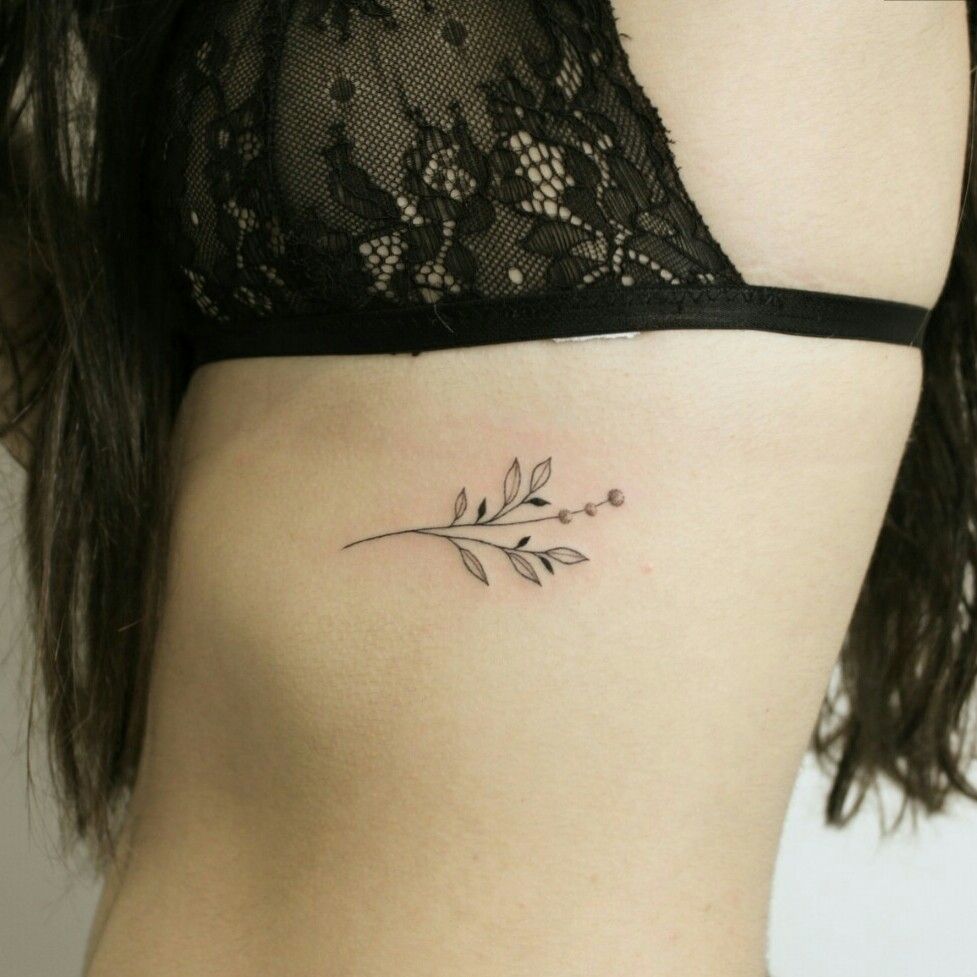 Lavender flower tattoo on the right side ribcage