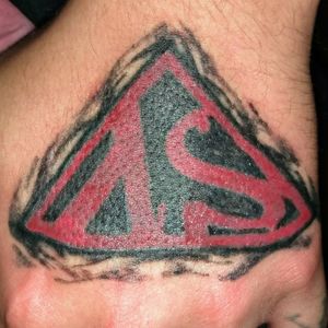 This is a cover up of another identical symbol. I guess it's the logo for some kind of comic called "supervillains?"Never heard of it, but whatevs.