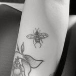 A simple bee on the client's right forearm