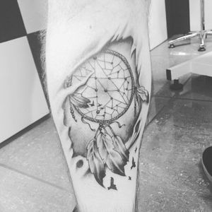 My first tattoo, done a couple years ago. It is a ripped skin dream catcher, captured in black and white. Includes a lot of shading took around 2 hours to complete. 