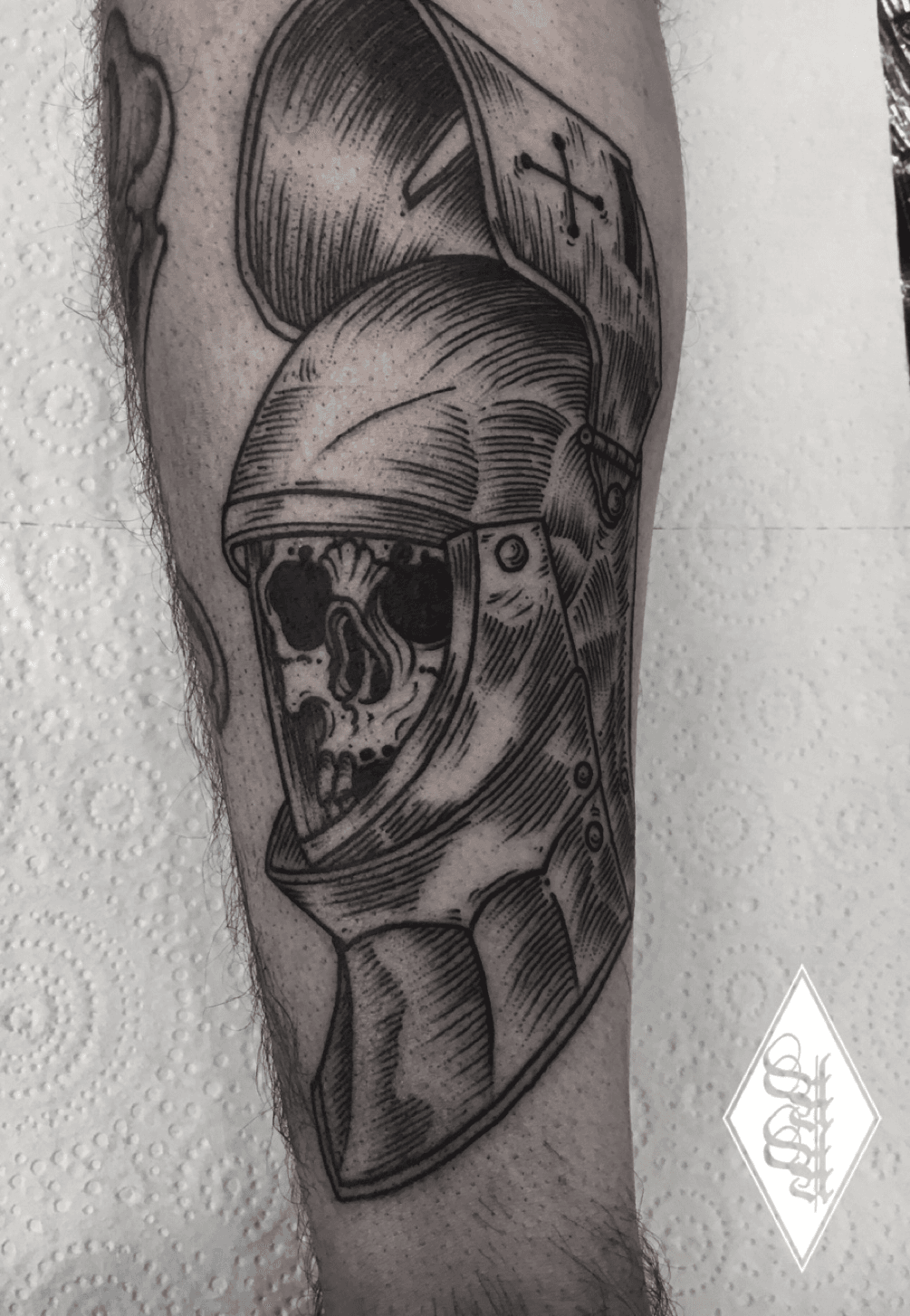 Sketch work skull knight tattoo on the inner forearm