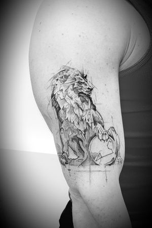 Lion statue tattoo