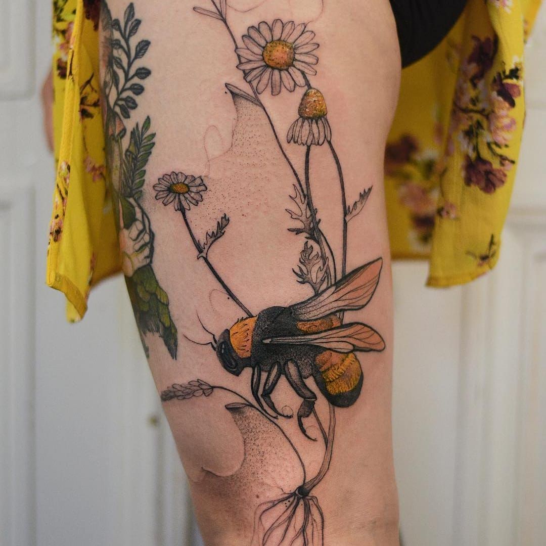 Watercolor style bee tattooed on the inner forearm