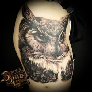 Black and grey owl on hip.