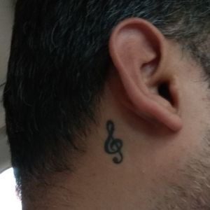 Music symbol behind right ear