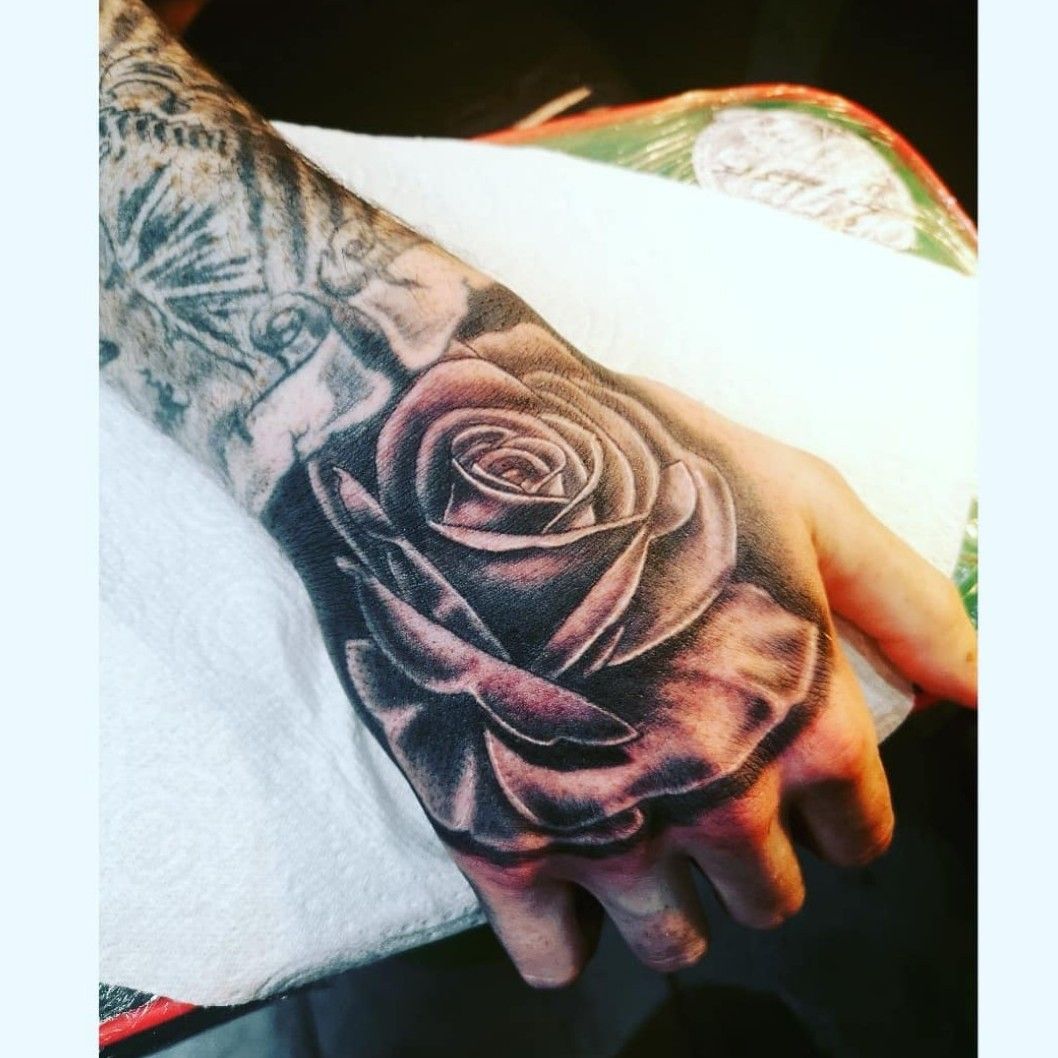 rose tattoo black and white on hand