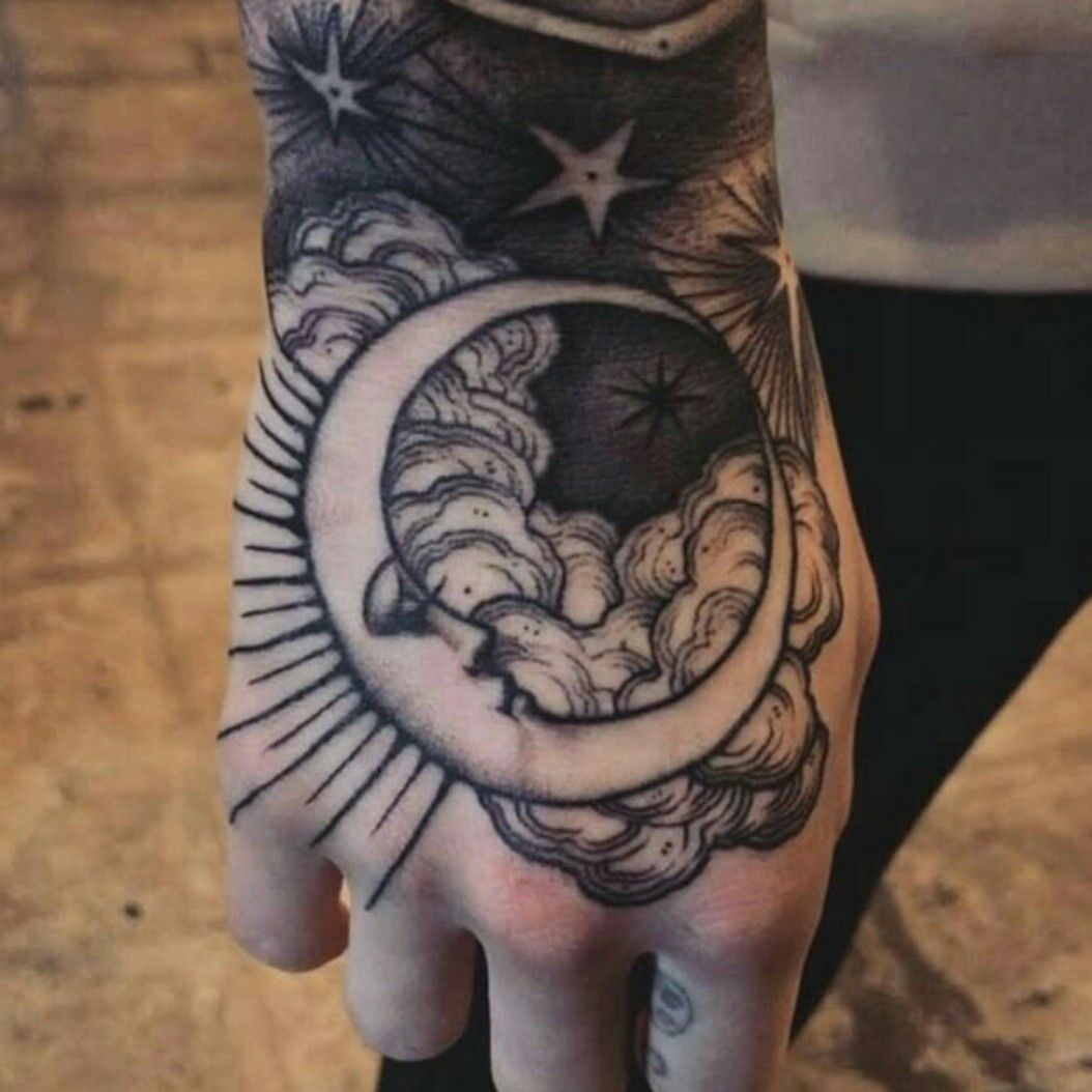 Minimalistic crescent moon tattoo located on the hand