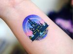 Tattoo by Jury Tattoo #JuryTattoo #Disneytattoo #Disney #cartoon #animation #castle #color #watercolor #Disneycastle #moon #sparkles #sky #night #lights