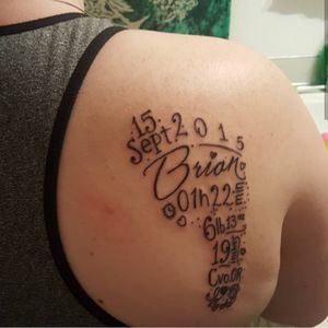 A tattoo I got for my son. It includes all his birth information all in the shape of a foot.