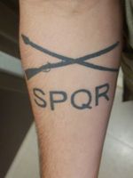 Variant of the infantry crossed rifles with a crossed spear representing the Roman god of war, Mars, and the phrase SPQR, or the Senate and People of Rome