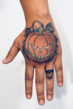 Jack-o-lantern hand tattoo
