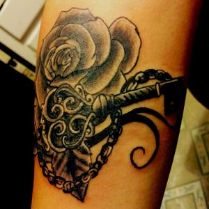 Rose with key on inner forearm