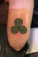 Triple spiral celtic symbol above the elbow 