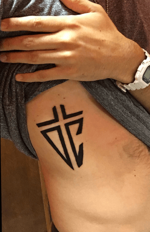 My initials "TDC" and a Cross in the negative space.