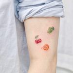 Tattoo by Nemo Tattoo #NemoTattoo #foodtattoos #food #foodporn #realistic #realism #hyperrealism #color #grapes #cherry #cherries #orange #fruit #tiny #small