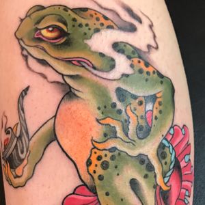 Experience the mystical allure of a Japanese styled frog tattoo on your arm by the talented artist Darren Brass.