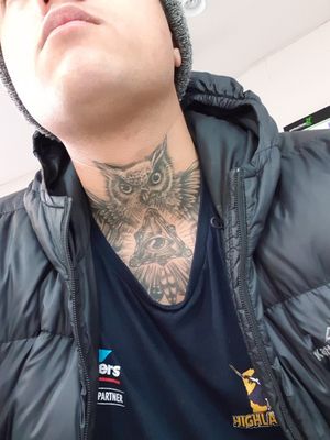Neck tattoo of and owl and all seeing eye