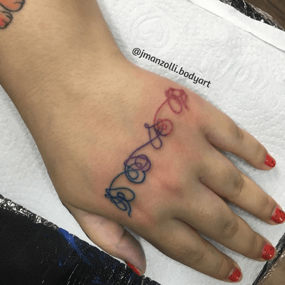 Fine line BTS heart tattoo on the wrist
