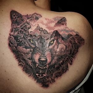 Wolf tattoo by Sean at www.adventuretattoos.com #wolftattoo #wolf #wolfspirit #wolfart #wolfsheadtattoo #wolves #blackandgrey #mountains 