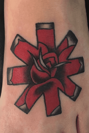 RHCP rose on the foot, this was her first tattoo and she sat like a rock! 