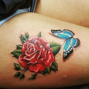Beautiful red rose and butterfly by Sean at www.adventuretattoos.com #inkedadventure #www.adventuretattoos.com #femaletattoo #butterflytattoo #roseandbutterfly #thightattoo #bluebutterfly #rose #redrose #butterfly 
