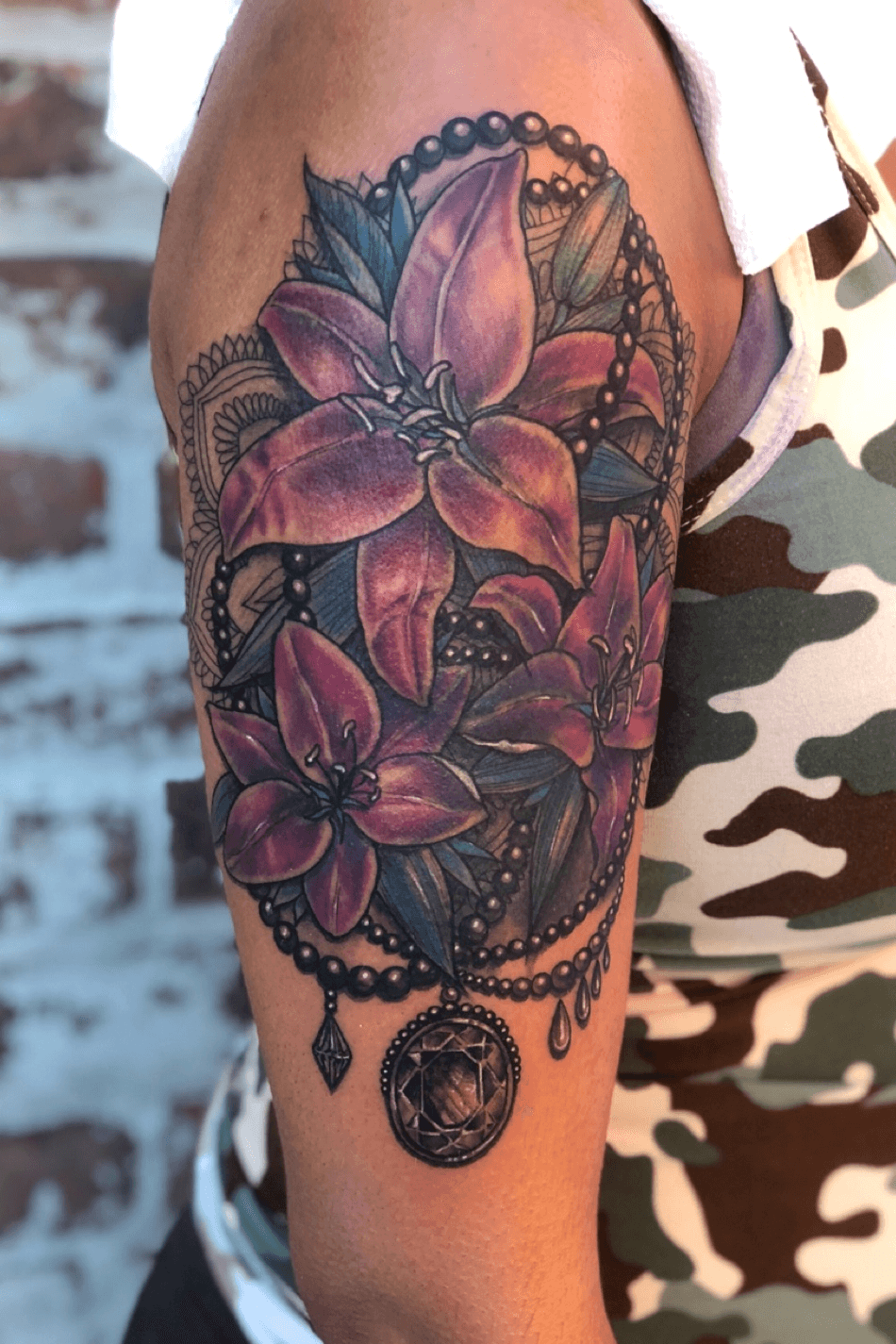 Beautiful half wrap around colored Tiger Lily tattoo on wrist  Tiger lily  tattoos Cover tattoo Wrist tattoo cover up
