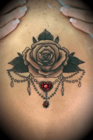 Rose jewel sternum tattoo.