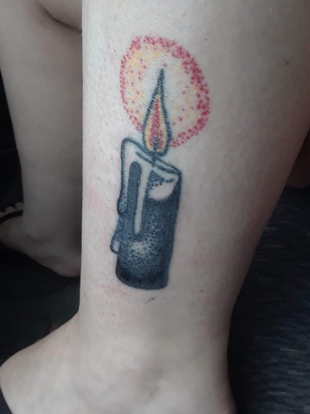 Candle tattoo on the left bicep