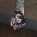 Tattoo by Jefree Naderali #JefreeNaderali #handtattoo #hand #jobstopper #blackandgrey #portrait #realistic #realism #hyperrealism #MarlaSinger #FightClub #HelenaBonhamCarter #smoke #ladyhead