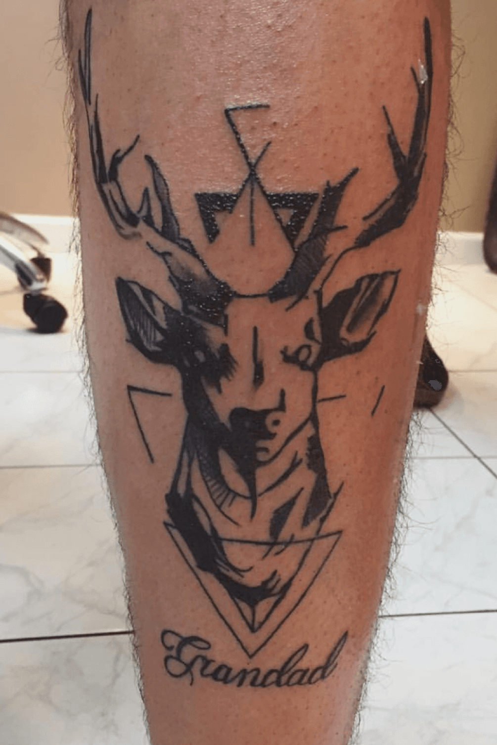 Black And Grey Geometric Deer Head Tattoo On Forearm