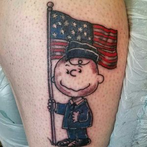 Charlie Brown Patriotic Memorial Tattoo.  #charliebrown #americanflag #tattooart #tattooartist #illustrative #militarytattoos #girlswithtattoos #turtlestyletattoocompany #freshink #cartoontattoo #memorialtattoo 
