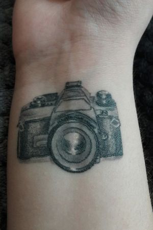 My first tattoo. Represents my love for photography and my mother being a photographer. ......#wristattoo  #cameratattoo #photography #blackandgreytattoo #firstattoo #dotworktattoo #lineworktattoo 