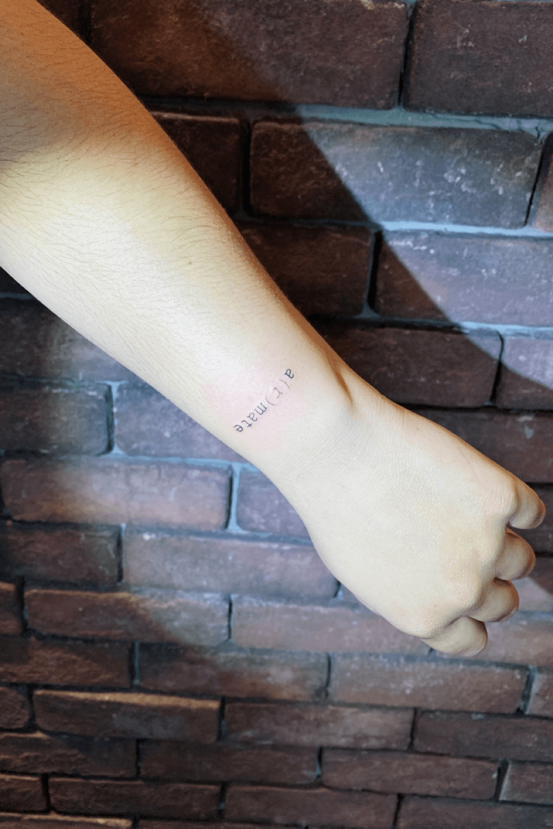 Typewriter smile tattoo on the wrist