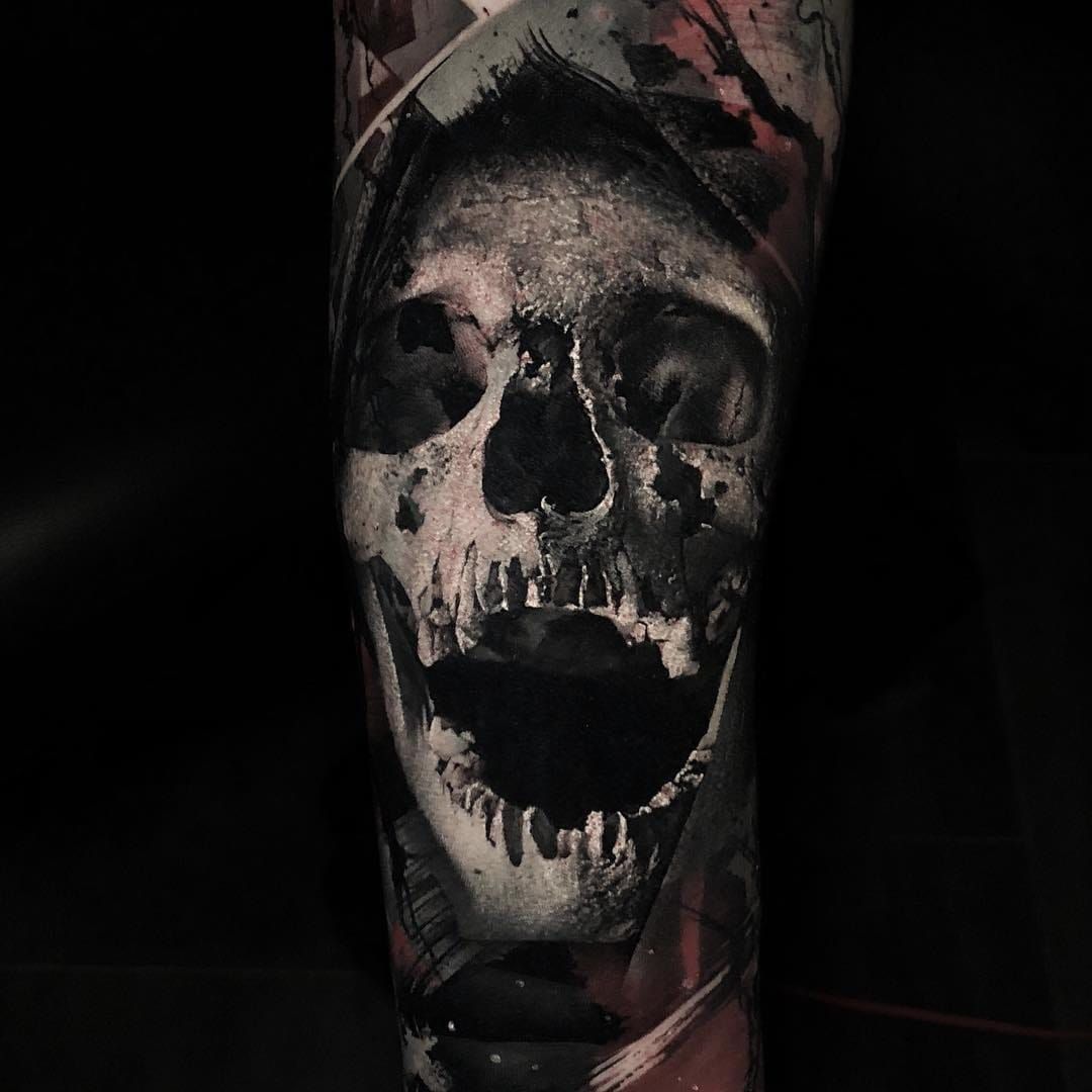 Realistic black and opaque gray skull tattoo on forearm by Sorin Gabor  TattooNOW