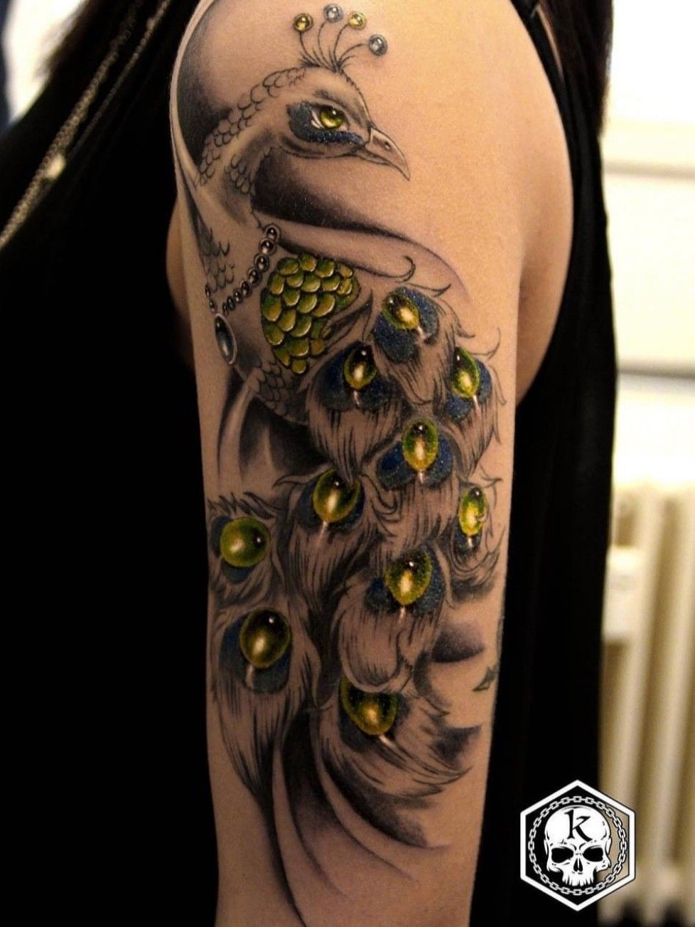 Peacock tattoo on the right thigh