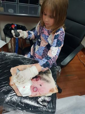 Bosses daughter Scarlett having a go on pig skin